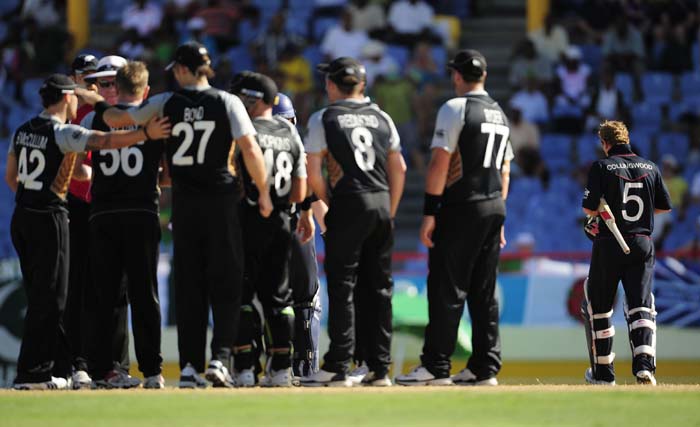 English captain Paul Collingwood makes his way to the pavilion as New Zealand players celebrate his dismissal.(AFP PHOTO) WT20: NZ vs Eng