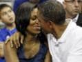 Obamas pose for Kiss Cam during a basketball match