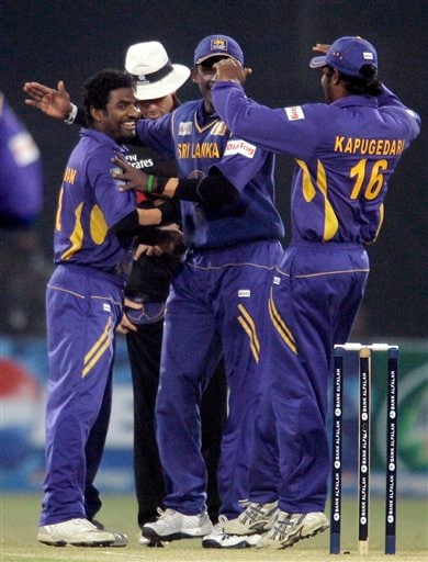 Muttiah Muralitharan is congratulated by teammates after taking his 500th wicket during the third one-day international cricket match against Pakistan at Gaddafi Stadium in Lahore on Saturday, January 24, 2009. Muralitharan became the only second bowler after former Pakistan quick Wasim Akram (502) to take 500 ODI wickets, finishing with 2-2. (AP Photo) 3rd ODI: Pakistan vs Sri Lanka