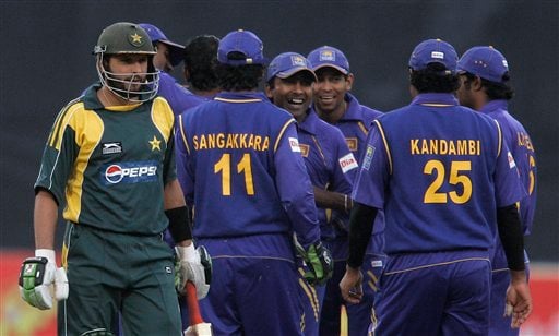 Shahid Afridi, left, walks back to pavilion as Sri Lankan players celebrate his dismissal during their third one-day international cricket match at Gaddafi Stadium in Lahore on Saturday, January 24, 2009. (AP Photo) 3rd ODI: Pakistan vs Sri Lanka