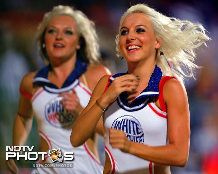 They may be smiling here but the RCB cheer girls had little to cheer in the initial stages of the chase. Tillakaratne Dilshan and Mayank Agarwal were removed early by the Pune bowlers. (AFP PHOTO/Manjunath KIRAN) IPL 5: Bangalore down Pune in a thriller