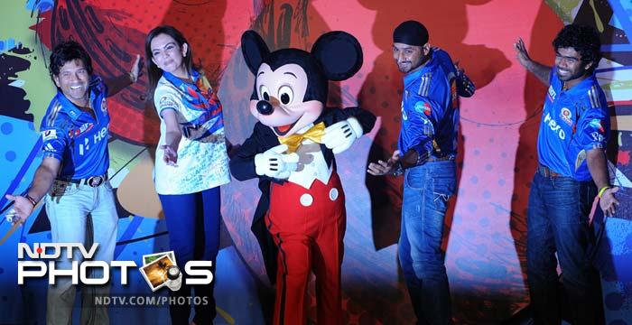 Mumbai Indians' bowler Lasith Malinga (R) joins in the fun and poses with team-mate Sachin Tendulkar (L), team owner Nita Ambani (2L) and team captain Harbhajan Singh (2R) with Disney character Mickey Mouse (C). (AFP PHOTO/Indranil MUKHERJEE) Sachin, Harbhajan's day out with Mickey Mouse
