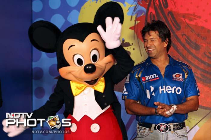 Sachin Tendulkar poses for a photograph with Mickey Mouse during the unveiling of Mumbai Indians' limited edition merchandise range called 'Mickey Cricket' in Mumbai. (AP Photo/ Rajanish Kakade) Sachin, Harbhajan's day out with Mickey Mouse