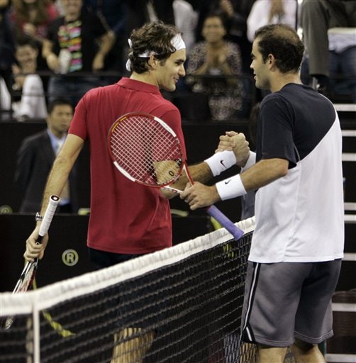 Roger Federer of Switzerland, left, shakes hands with Pete Sampras of the United States. Sampras stuns Roger