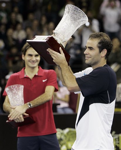 Pete Sampras, right, and Roger Federer celebrate after a friendly match in Macau. Sampras stuns Roger