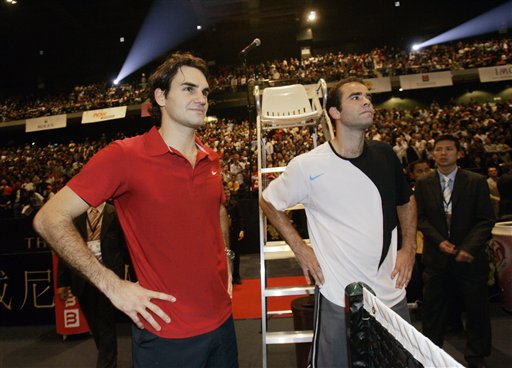 Roger Federer, left, and Pete Sampras gesture after the friendly match. Sampras stuns Roger