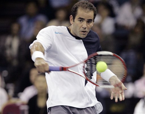 Pete Sampras returns the ball. Sampras stuns Roger