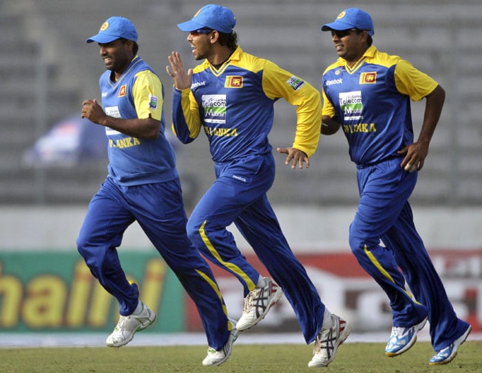 Sri Lanka's Chamara Silva, Tillakaratne Dilshan, and Muthumudalige Pushpakumara run to celebrate the dismissal of Bangladesh's Shakib Al Hasan during their first One-Day International of the tri-series in Dhaka. (AP Photo) 1st ODI: SL vs B'desh