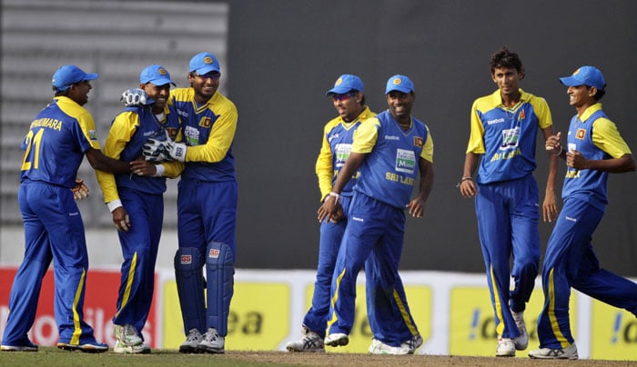 Sri Lankan cricketers celebrate the dismissal of Bangladesh's Raqibul Hasan, unseen, during their first One-Day International of the tri-series in Dhaka. (AP Photo) 1st ODI: SL vs B'desh