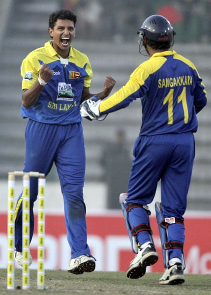Sri Lanka's Suraj Randiv celebrates with captain Kumar Sangakkara the dismissal of Bangladesh's Mushfiqur Rahim during their first One-Day International of the tri-series in Dhaka. (AP Photo) 1st ODI: SL vs B'desh