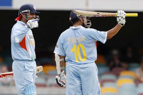 Sachin Tendulkar, right, gestures the stands as his team-mate Virender Sehwag, left, comes in after reaching 16,000 runs during their On-Day cricket international against Sri Lanka in Brisbane on Tuesday, February 5, 2008. 2nd Match: India-Lanka