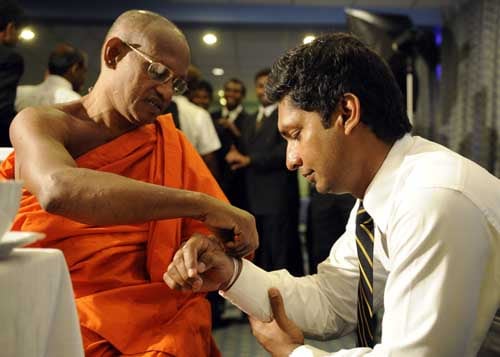 Kumar Sangakkara is blessed by a Buddhist monk in Colombo before leaving for England to play in the ICC Twenty20 World Cup. (AFP Photo) Sri Lankans leave for T20 WC