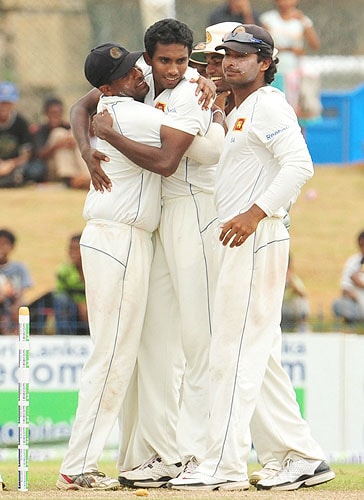 Sri Lankan cricketer Thilan Thushara celebrates with teammates Thilan Samaraweera, Tharanga Paranavitana and captain Kumar Sangakkara after he dismissed New Zealand batsman Brendon McCullum during the third day of the first Test match at The Galle International Cricket Stadium in Galle on Thursday. (AFP Photo) SL vs NZ: 1st Test, Day 3