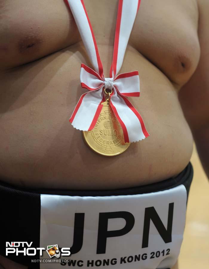 A member of the Japanese men's team is pictured with his gold medal after their victory in the men's team competition at the 18th Sumo World Championships in Hong Kong on October 28, 2012. Japan won the team event, with Russia in second place.