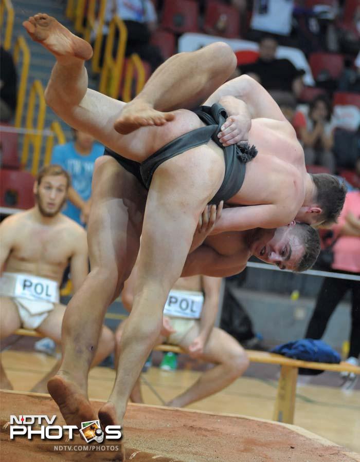 Pieter Vroon of the Netherlands (top) beats Oleksandr Gordienko of Ukraine during the men's team competition.