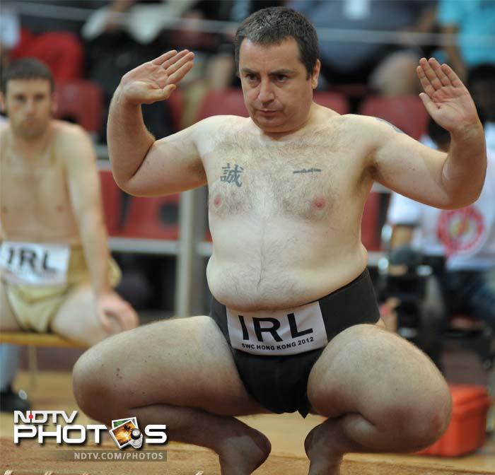 John Gunning of Ireland enters the ring for his bout as teammate Owen Cunningham (back L) looks on.