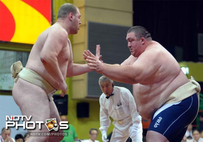 Alan Karaev of Russia (R) fights against Dmytro Slepchenko of Ukraine (L) in the men's heavyweight final competition at the 18th Sumo World Championships in Hong Kong. Karaev finished first in the division to take home the trophy.