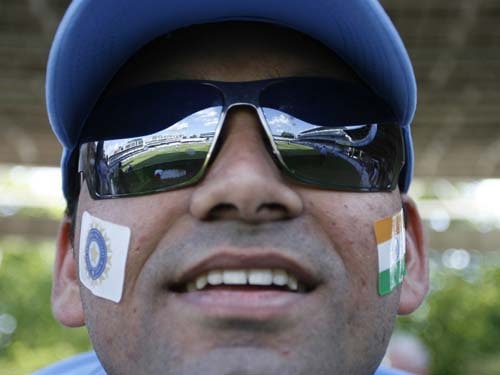 An Indian supporter watches the Indian team before a warm up match against New Zealand at Lord's in London on Monday. (AFP Photo) India vs NZ warm-up match