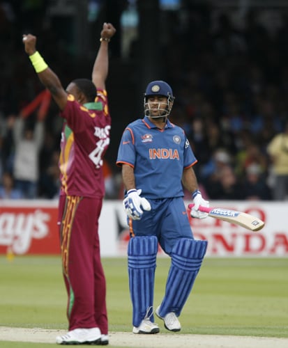 Dwayne Bravo celebrates taking the wicket of MS Dhoni caught by Andre Fletcher during the ICC World Twenty20 match at Lord's in London. (AFP Photo) WT20: IND vs WI