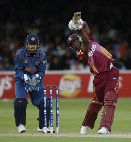 Dwayne Bravo plays a shot watched by Mahendra Singh Dhoni during the ICC World Twenty20 match at Lord's in London. (AFP Photo) WT20: IND vs WI