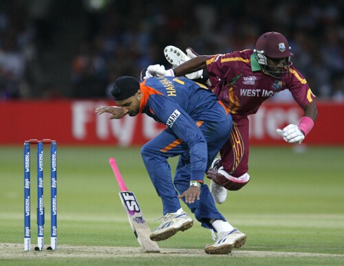 Dwayne Bravo collides with Harbhajan Singh after trying to avoid a runout during the ICC World Twenty20 match at Lord's in London. (AFP Photo) WT20: IND vs WI