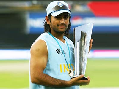 M S Dhoni, captain of the Indian ODI team, holding the Twenty20 WC trophy, a proof of how much a young team could achieve without a full-time coach. India's hunt for a coach