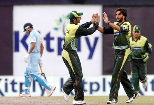 Shahid Afridi celebrates the wicket of Yusuf Pathan with skipper Shoaib Malik during the second ODI against India in Dhaka. (AFP Photo) 2nd ODI: India vs Pakistan