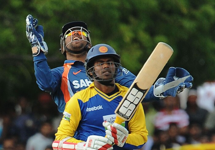 Mahendra Singh Dhoni celebrates after he takes a catch to dismiss Upul Tharanga during the final ODI of the Micromax tri-series between Sri Lanka and India in Dambulla. (AFP Photo) Tri-series final: India vs SL
