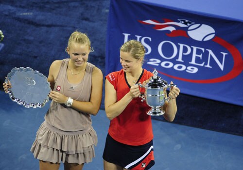 Kim Clijsters from Belgium celebrates and Caroline Wozniacki from Denmark hold their trophy at the end of the women's final of the 2009 US Open in New York. (AFP Photo) US Open Day 14