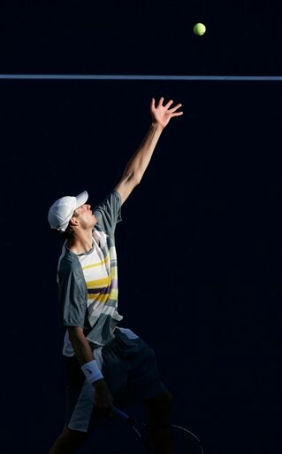 John Isner of the United States serves to Roger Federer of Switzerland at the US Open tennis tournament in New York on Saturday. US Open - Day 6