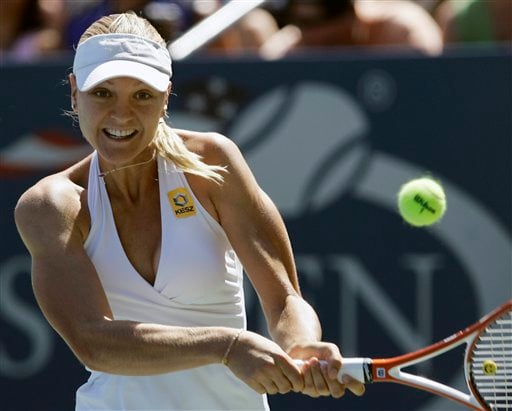 Agnes Szavay of Hungary backhands a shot to Nadia Petrova of Russia at the US Open tennis tournament in New York on Saturday. US Open - Day 6