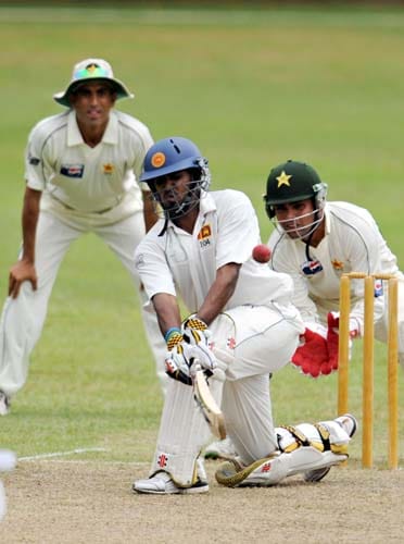 Chamara Kapugedera hits a stroke while watched by Kamran Akmal during the first day of a three-day practice match between Pakistan and Sri Lanka Board XI in Colombo on June 29, 2009. (AFP Photo) Warm-up: PAK vs SL