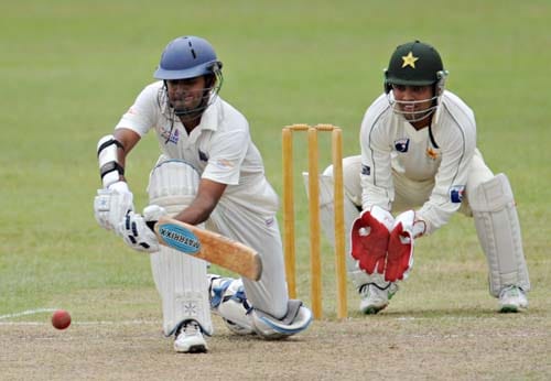 Lahiru Thirimanne hits a stroke while watched by Kamran Akmal during the first day of a three-day practice match between Pakistan and Sri Lanka Board XI in Colombo. (AFP Photo) Warm-up: PAK vs SL