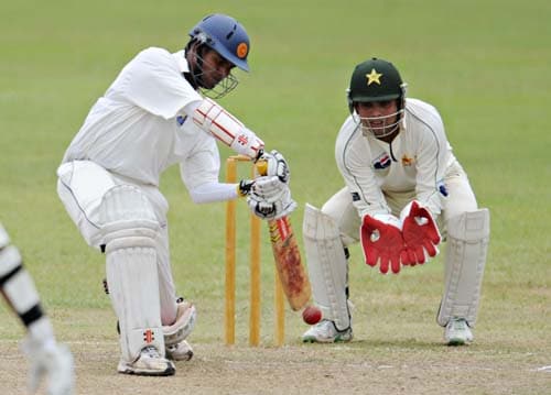 Upul Tharanga hits a stroke while watched by Kamran Akmal during the first day of a three-day practice match between Pakistan and Sri Lanka Board XI in Colombo. (AFP Photo) Warm-up: PAK vs SL