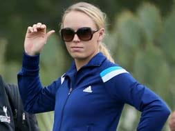 Out of Australian Open, Wozniacki joins Rory for golf
