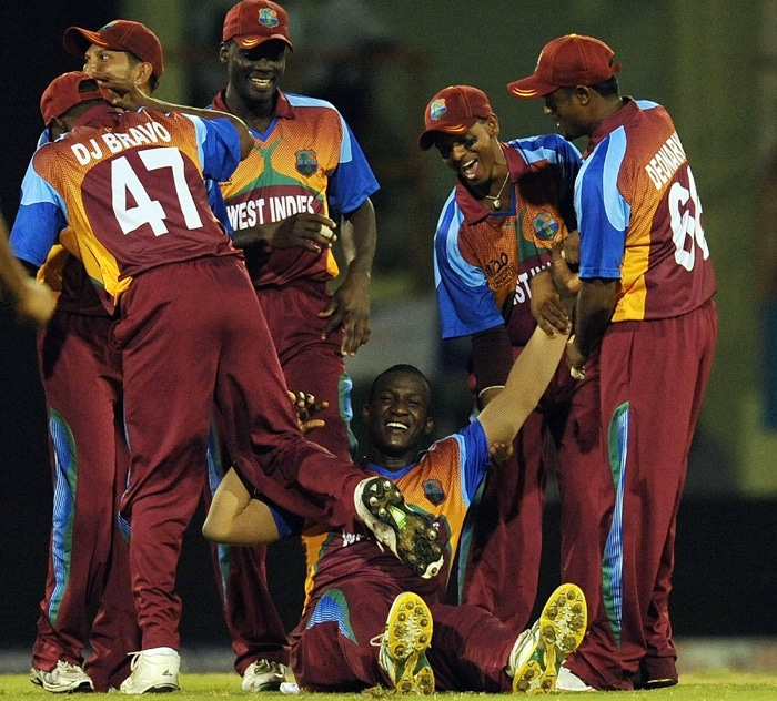 West Indies cricketers greet teammate Darren Sammy for the wicket of George Dockrell of Ireland and their victory during their ICC World Twenty20 2010 match at the Providence Stadium in Guyana on April 30, 2010. West Indies won the match by 70 runs. (AFP Photo) T20 WC: WI vs IRE