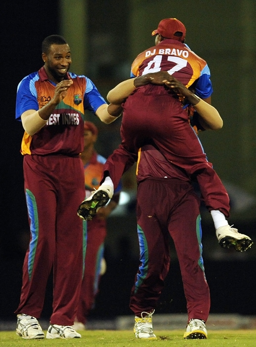 West Indies cricketers Kieron Pollard and Dwayne Bravo celebrate with Darren Sammy the wicket of George Dockrell of Ireland and their victory during their ICC World Twenty20 2010 match at the Providence Stadium in Guyana on April 30, 2010. West Indies won the match by 70 runs.(AFP Photo) T20 WC: WI vs IRE