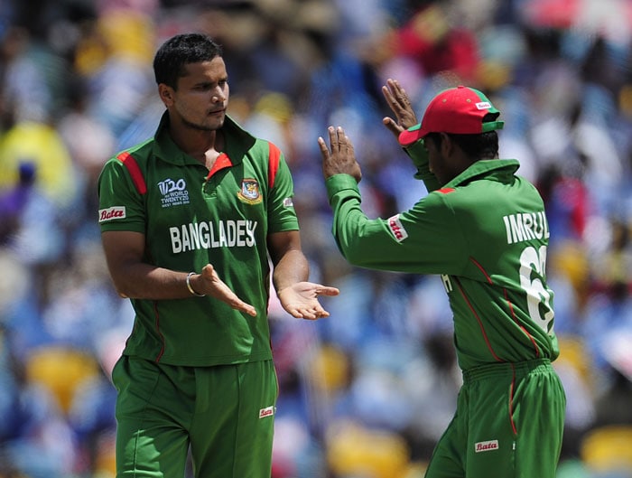 Mashrafe Mortaza (L) with celebrates Imrul Kayes after taking the wicket of Australian batsman Shane Watson during the ICC World Twenty20 Group A match between Bangladesh and Australia at the Kensington Oval. (AFP Photo) WT 20: Aus vs Ban