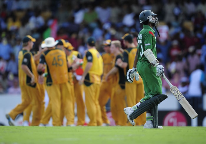 Shakib Al Hasan leaves after being dismissed as Australian players celebrate during the ICC World Twenty20 Group A match between Bangladesh and Australia at the Kensington Oval. (AFP Photo) WT 20: Aus vs Ban