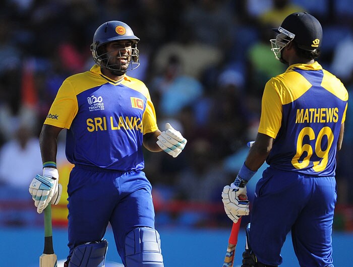 Sri Lankan batsman Chamara Kapugedara (L) and Angelo Mathews celebrate their partnership during the ICC World Twenty20 Super Eight match between India and Sri Lanka at the Beausejour Cricket Ground. (AFP Photo) WT20: Ind vs SL