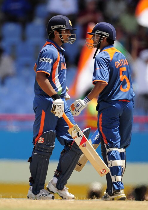 Suresh Raina (L) and Gautam Gambhir celebrate a boundary during the ICC World Twenty20 Super Eight match between India and Sri Lanka at the Beausejour Cricket Ground. (AFP Photo) WT20: Ind vs SL