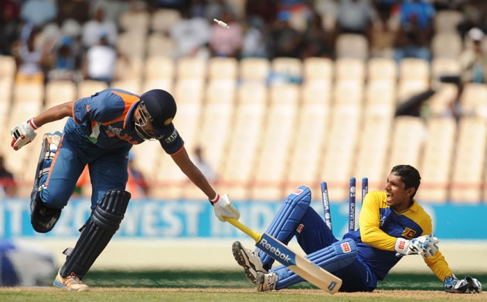 Yusuf Pathan(L) lunges to each his crease as Sri Lankan Kumar Sangakkara appeals for his run-out during the ICC World Twenty20 Super Eight match between Sri Lanka and India at the Beausejour Cricket Ground. (AFP Photo) WT20: Ind vs SL