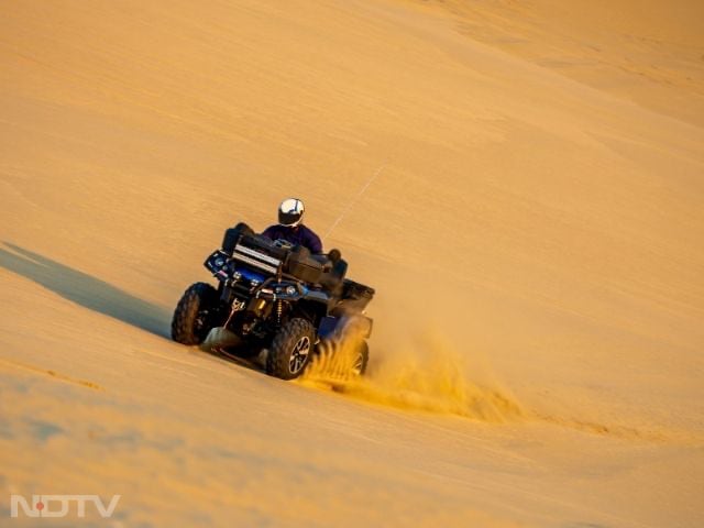 Dune Bashing: Experience a thrilling desert adventure with expert drivers navigating dunes in 4x4s. Wear comfortable clothes and sturdy shoes.