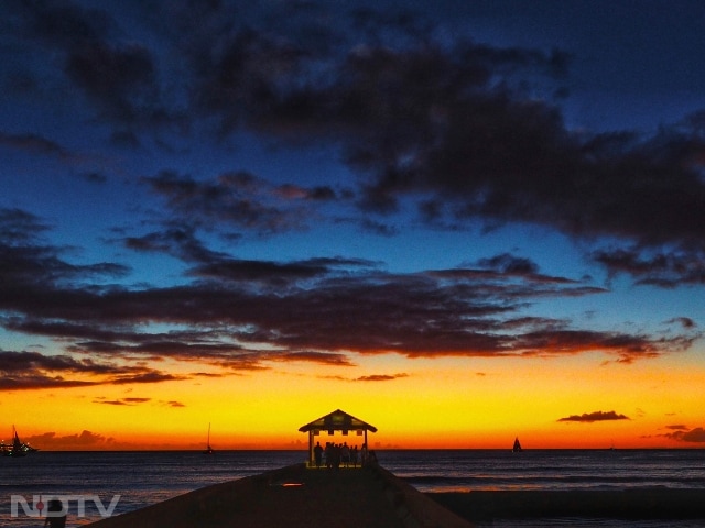 2. Waikiki Beach, Hawaii
Waikiki Beach is known for its surf culture and laid-back charm. Feel the breeze as you watch the sun dip into the Pacific, painting the sky in calming shades.