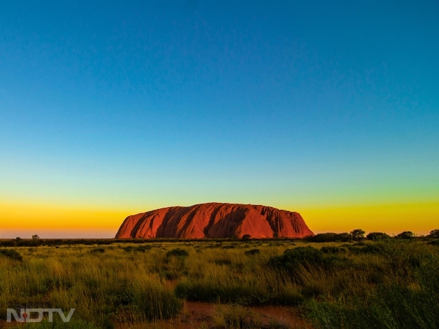 4. Uluru, Australia
This sandstone monolith in Australia's Northern Territory turns a deep red-orange at sunset. Uluru's shifting colours make it a powerful and visually striking sight.