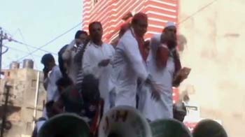 Akhilesh's party workers throw money in the air to celebrate