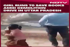 Girl Runs To Save Books Amid Demolition Drive In UP, Video Goes Viral Girl Runs To Save Books Amid Demolition Drive In UP, Video Goes Viral