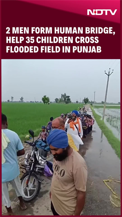 Video: Two Men Form Human Bridge, Help 35 Children Cross Flooded Field In Punjab