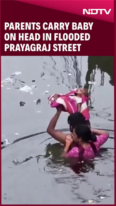 Video: Uttar Pradesh: Parents Carry Baby On Head In Flooded Prayagraj Street