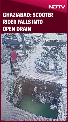 Scooter Rider Falls Into Open Drain Outside Gaur Green City Market In Ghaziabad